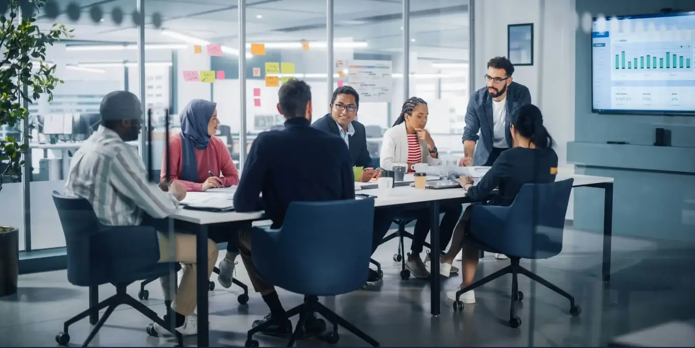 people discussing and working around conference table