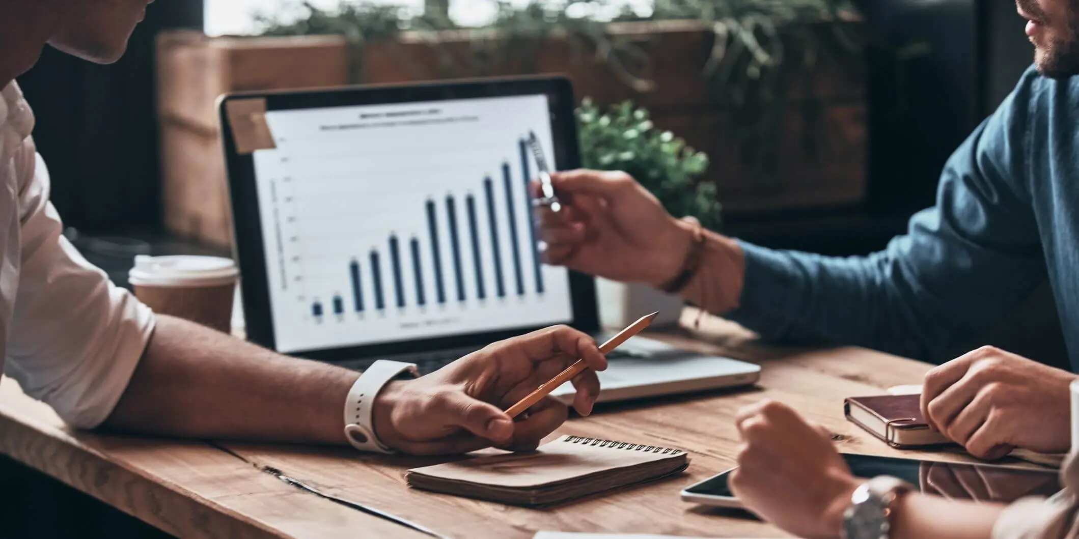 people discussing analytics on laptop